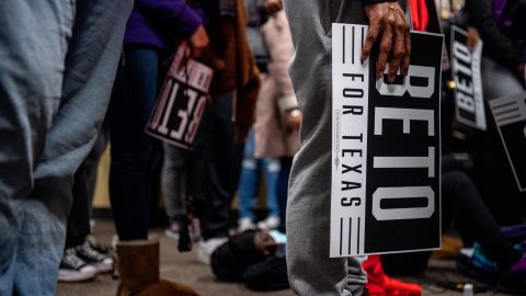 College students carry Beto O'Rourke signs during the rally at Prairie View A&M University on February 25, 2022.
