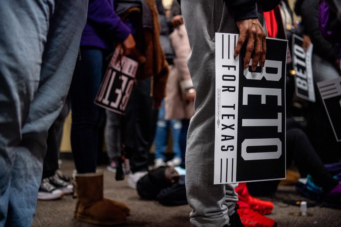 College students carry Beto O'Rourke signs during the rally at Prairie View A&M University on February 25, 2022.
