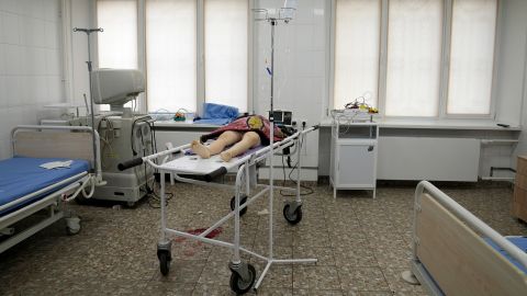 The girl's lifeless body lies in the hospital room, covered by her jacket.