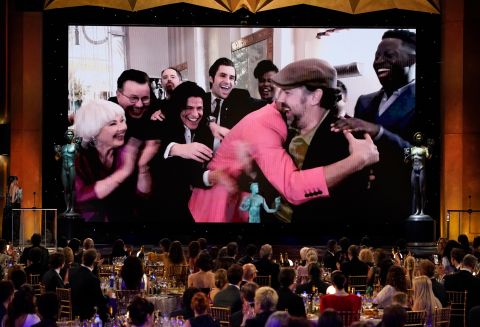 Jason Sudeikis, appearing remotely, is embraced by his "Ted Lasso" co-stars after winning the SAG award for outstanding performance by a male actor in a comedy series.