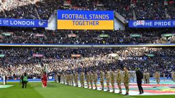 TOPSHOT - A 'Football Stands Together' message is displayed in Ukrainian colours ahead of the English League Cup final football match between Chelsea and Liverpool at Wembley Stadium, north-west London on February 27, 2022. - Russian billionaire Roman Abramovich handed over control of Chelsea to trustees of its charitable foundation on Saturday as Premier League players showed their support for war-torn Ukraine. - RESTRICTED TO EDITORIAL USE. No use with unauthorized audio, video, data, fixture lists, club/league logos or 'live' services. Online in-match use limited to 120 images. An additional 40 images may be used in extra time. No video emulation. Social media in-match use limited to 120 images. An additional 40 images may be used in extra time. No use in betting publications, games or single club/league/player publications. (Photo by JUSTIN TALLIS / AFP) / RESTRICTED TO EDITORIAL USE. No use with unauthorized audio, video, data, fixture lists, club/league logos or 'live' services. Online in-match use limited to 120 images. An additional 40 images may be used in extra time. No video emulation. Social media in-match use limited to 120 images. An additional 40 images may be used in extra time. No use in betting publications, games or single club/league/player publications. / RESTRICTED TO EDITORIAL USE. No use with unauthorized audio, video, data, fixture lists, club/league logos or 'live' services. Online in-match use limited to 120 images. An additional 40 images may be used in extra time. No video emulation. Social media in-match use limited to 120 images. An additional 40 images may be used in extra time. No use in betting publications, games or single club/league/player publications. (Photo by JUSTIN TALLIS/AFP via Getty Images)