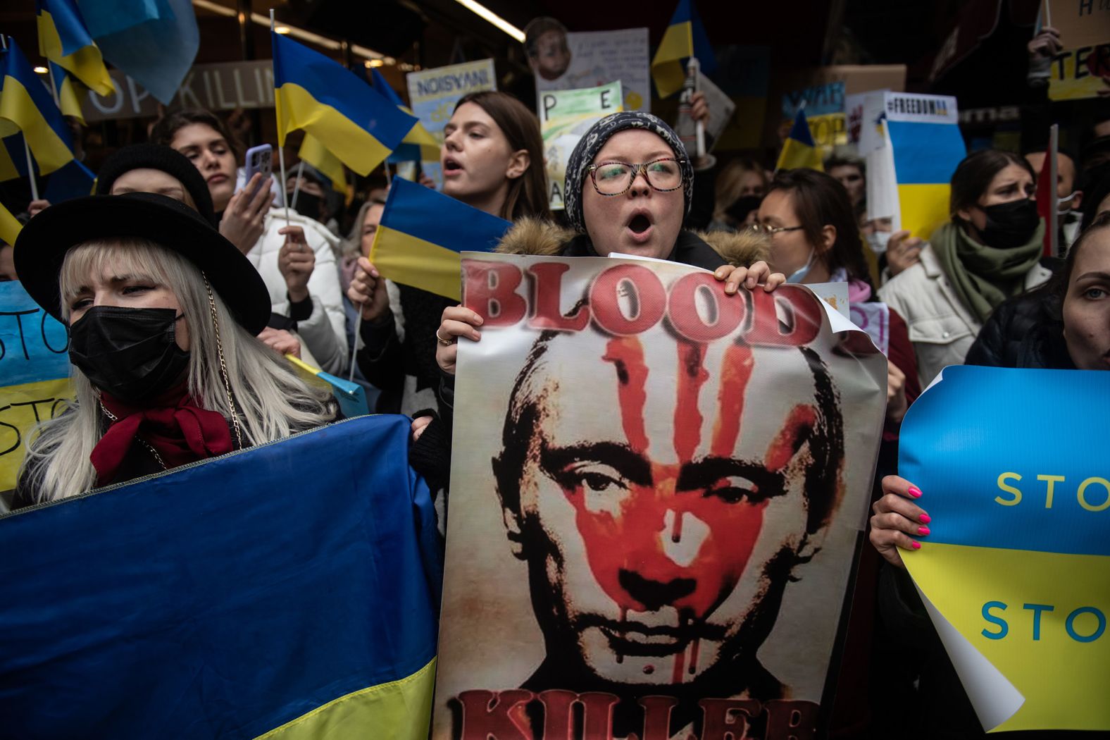 People gather to protest outside the Russian Consulate in Istanbul on February 25.