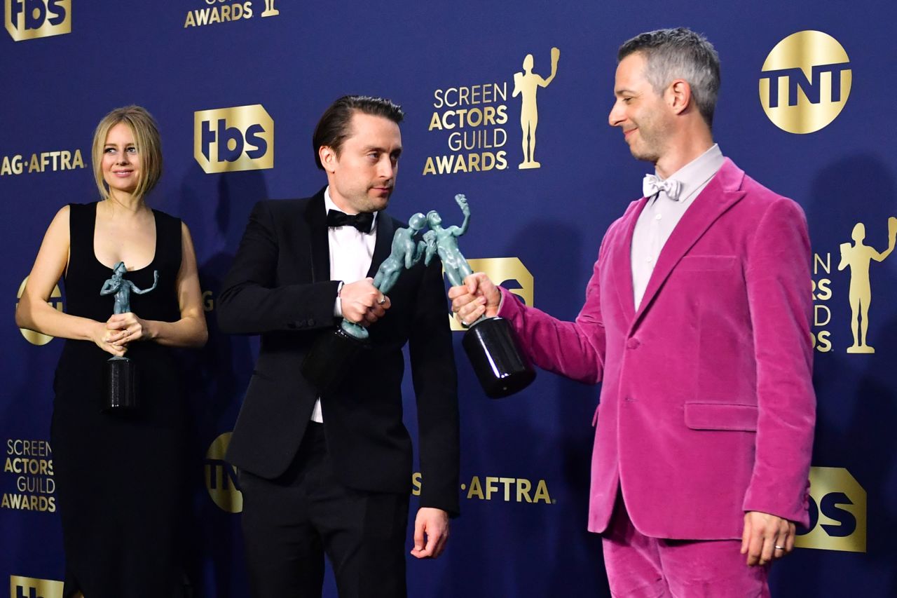 "Succession" actors Kieran Culkin, center, and Jeremy Strong bump awards after the show's cast won outstanding performance by an ensemble in a drama series.