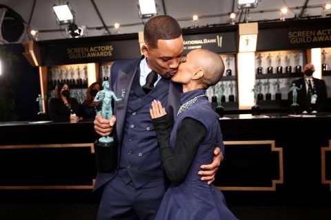 Will Smith kisses his wife, Jada Pinkett Smith, shortly after winning the award for outstanding performance by a male actor in a leading role. He played Richard Williams, the father of tennis greats Serena and Venus Williams, in the film "King Richard." Venus was in the audience with Smith and other cast members, too.