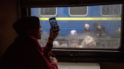 A passenger aboard a train at Lviv-Holovnyi railway station films displaced Ukrainians fleeing to Poland, in Lviv, Ukraine, on Sunday, Feb. 27, 2022. Ukrainian officials said they will meet Russian counterparts at the Belarus border, shortly after Vladimir Putin has put Russia's nuclear forces on higher alert. Photographer: Ethan Swope/Bloomberg via Getty Images
