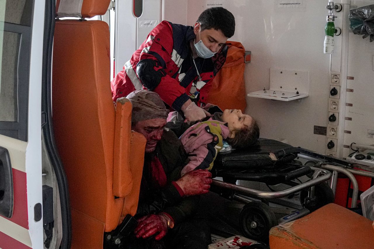 The girl, whose name was not immediately known, was injured by shelling in a residential area, according to the Associated Press. At left is her father.
