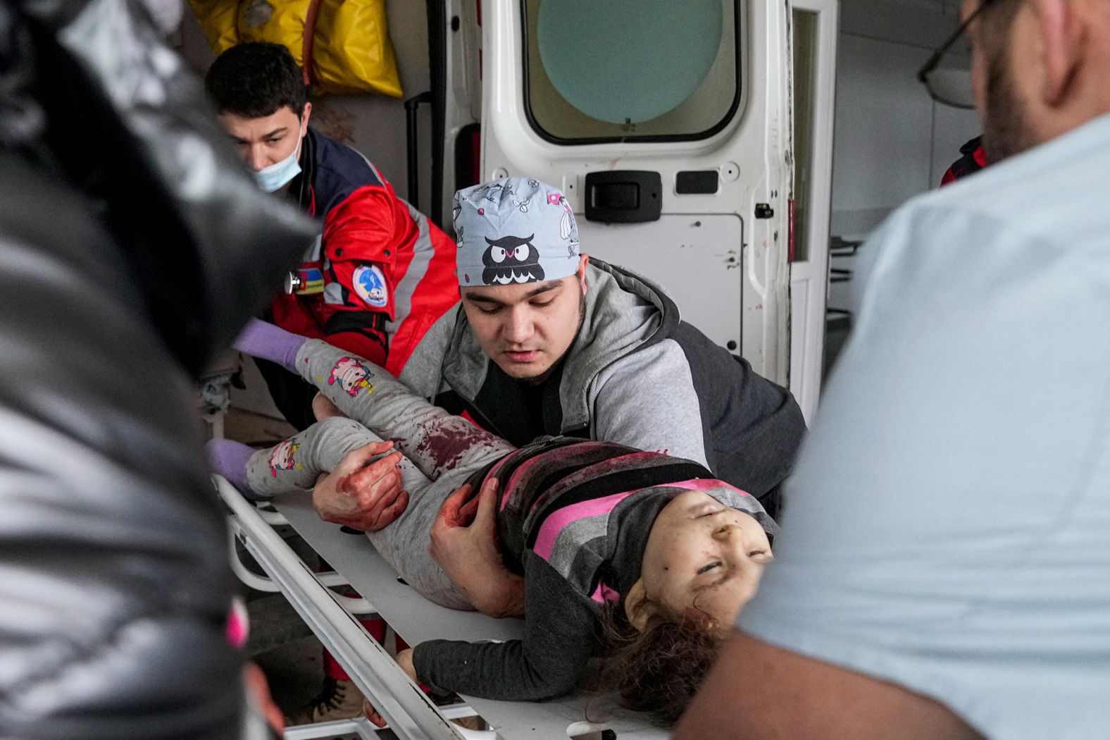 Hospital workers transport the girl onto a gurney to take her inside the hospital.