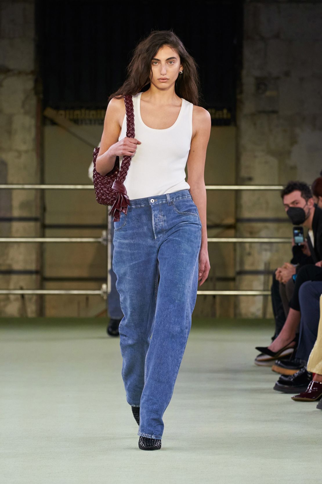A white tank top and blue trousers was the opening look in Matthieu Blazy's debut show for Bottega Veneta's Fall-Winter 2022 collection.