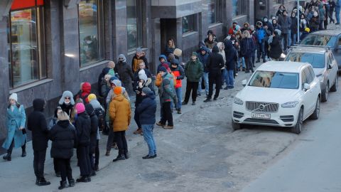 People stand in line to use an ATM money machine in Saint Petersburg, Russia February 27, 2022. 
