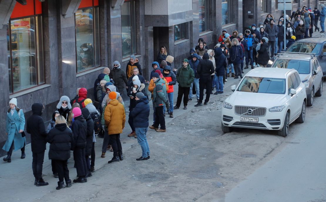 People stand in line to use an ATM money machine in Saint Petersburg, Russia February 27, 2022. 