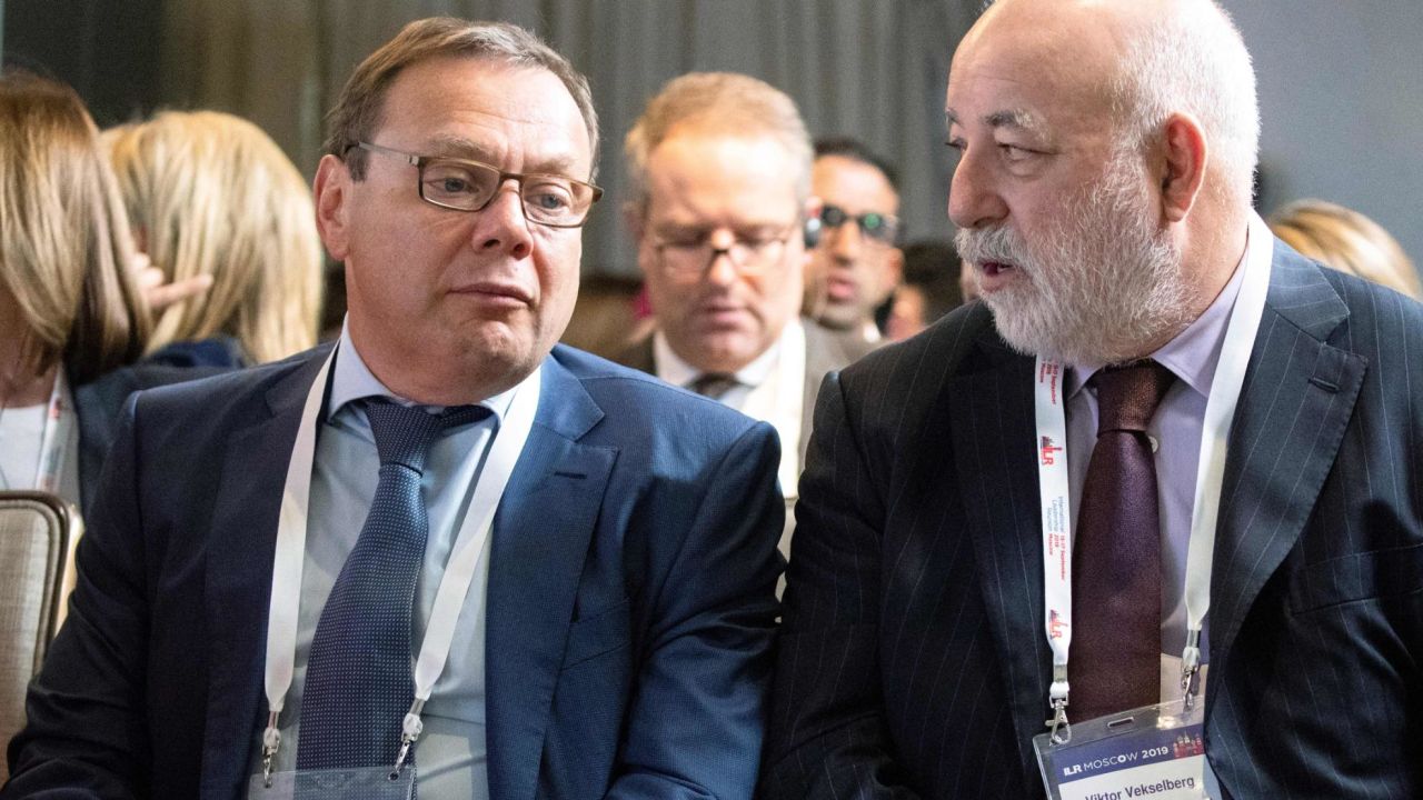 Russian businessman Mikhail Fridman, left, and businessman Viktor Vekselberg talk during a conference in Moscow on September 17, 2019.
