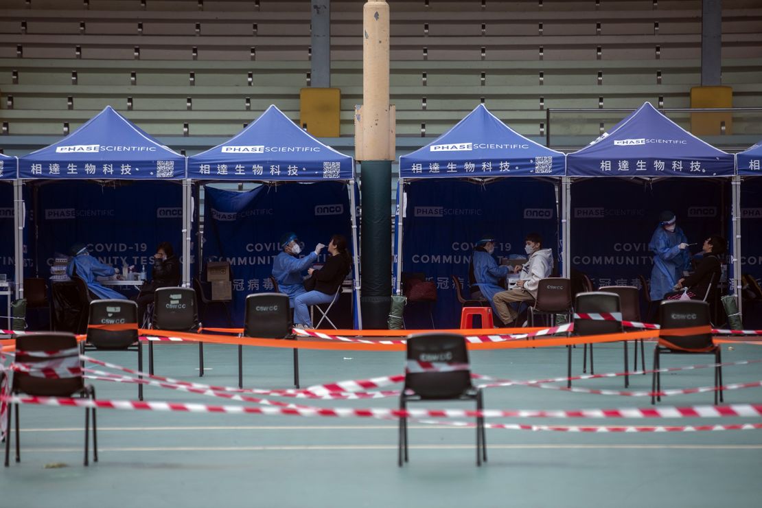 Health care workers collect swab samples at a Covid-19 testing facility in Hong Kong on February 24.