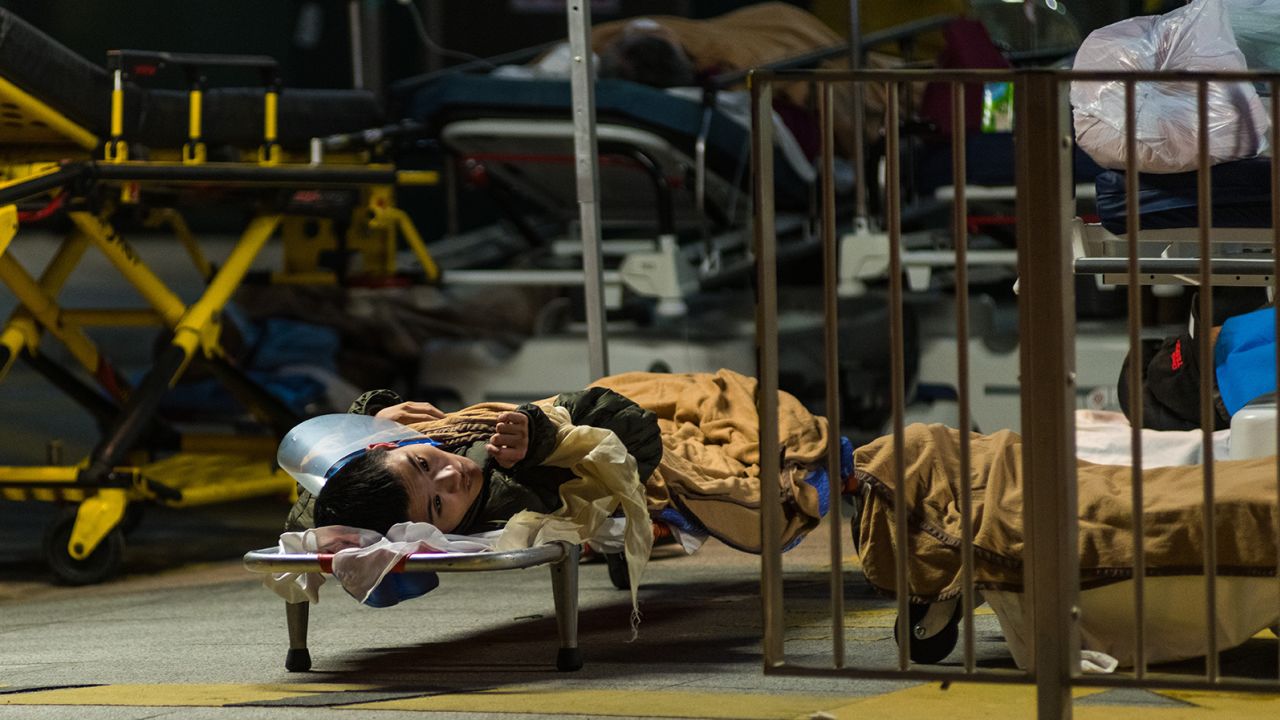 A Covid patient on a stretcher outside the Caritas Medical Centre in Hong Kong on February 25, 2022. 