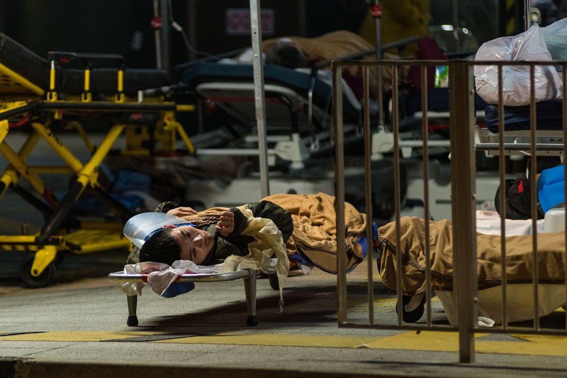 A Covid patient on a stretcher outside the Caritas Medical Centre in Hong Kong on February 25, 2022.