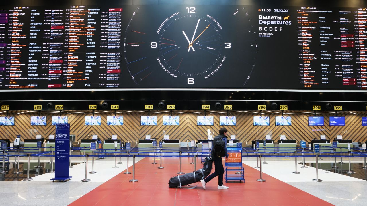A departures board shows canceled flights in a half-empty check-in area at Moscow's Sheremetyevo International Airport on February 28.