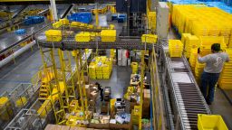 Bins move along a conveyor at an Amazon fulfillment center on Cyber Monday in Robbinsville, New Jersey, U.S., on Monday, Nov. 29, 2021. 