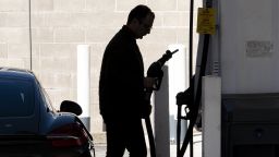 A driver removes a gas nozzle at a Shell gas station in San Francisco, California, U.S., on Friday, Feb. 25, 2022. 