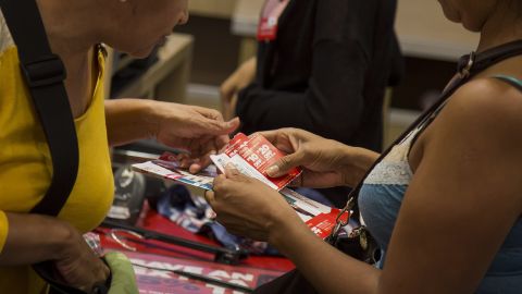 Customers use coupons while purchasing items at the checkout counter of a J.C. Penney Co. store at the Gateway Shopping Center in the Brooklyn borough of New York, U.S., on Saturday, Aug. 8, 2015.