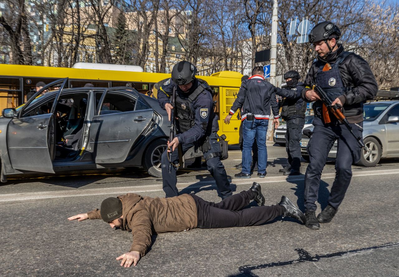 Ukrainian forces order a man to the ground on February 28 as they increased security measures amid Russian attacks in Kyiv.  Zelensky says Russia waging war so Putin can stay in power &#8216;until the end of his life&#8217; w 1280
