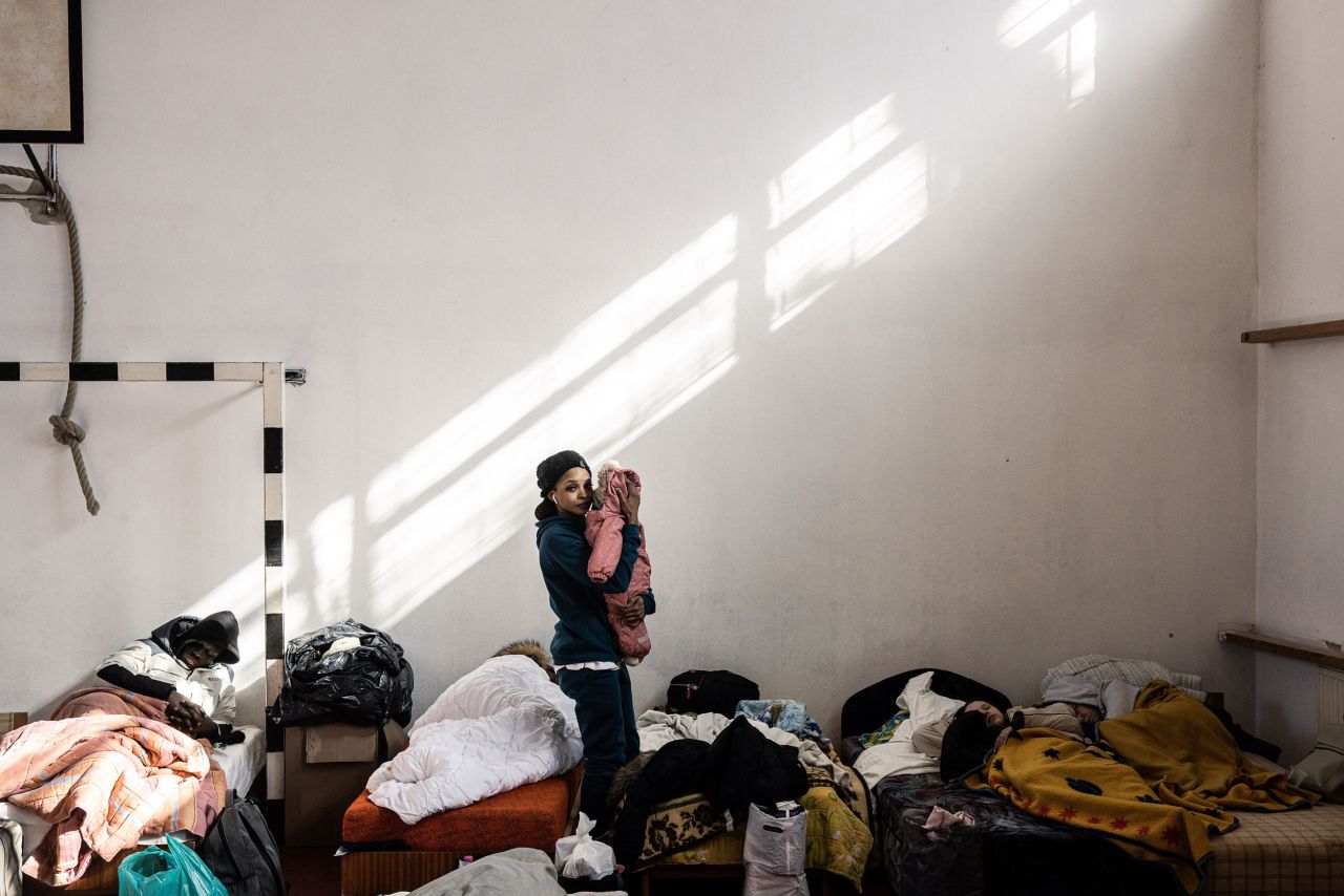 A displaced Ukrainian cradles her child at a temporary shelter set up inside a gymnasium in Beregsurány, Hungary, on February 28.