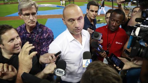 Former Miami Marlins CEO Derek Jeter, center, talks with members of the media before the start of a baseball game between the Marlins and the St. Louis Cardinals, in Miami, June 10, 2019.