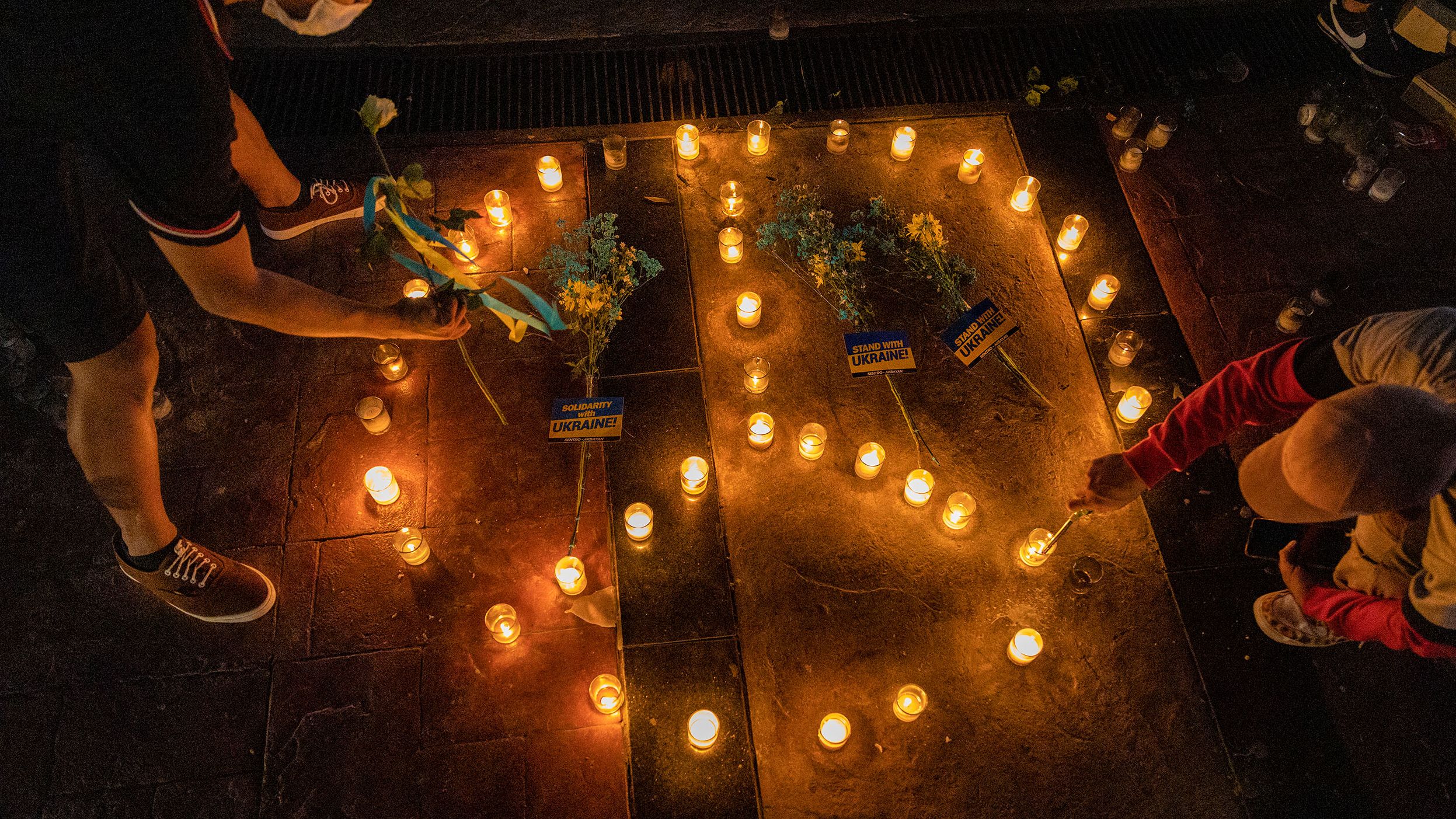 People in Quezon City, Philippines, light candles in the shape of a peace sign February 28 as they protest Russia's invasion of Ukraine.
