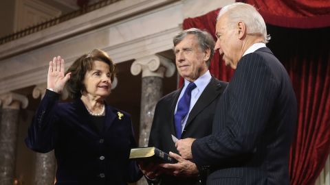 Sen. Dianne Feinstein participates in a reenacted swearing-in with her husband Richard C. Blum and then-Vice President Joe Biden in the Old Senate Chamber at the US Capitol  in January 2013 in Washington, DC. 