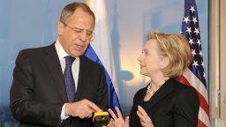 US Secretary of State Hillary Clinton (R) smiles with Russian Foreign Minister Sergei Lavrov after she gave him a device with red knob during a meeting on March 6, 2009 in Geneva. US Secretary of State Hillary Clinton meets Russian Foreign Minister Sergei Lavrov for the first time in Geneva today. The dinner meeting will discuss world tensions, ranging from Afghanistan to a planned US missile shield in Europe and Iran's nuclear programme. It will also lay the ground for the first encounter between US President Barack Obama and Russian counterpart Dmitry Medvedev at a London summit next month.  AFP PHOTO / FABRICE COFFRINI/POOL (Photo credit should read FABRICE COFFRINI/AFP via Getty Images)