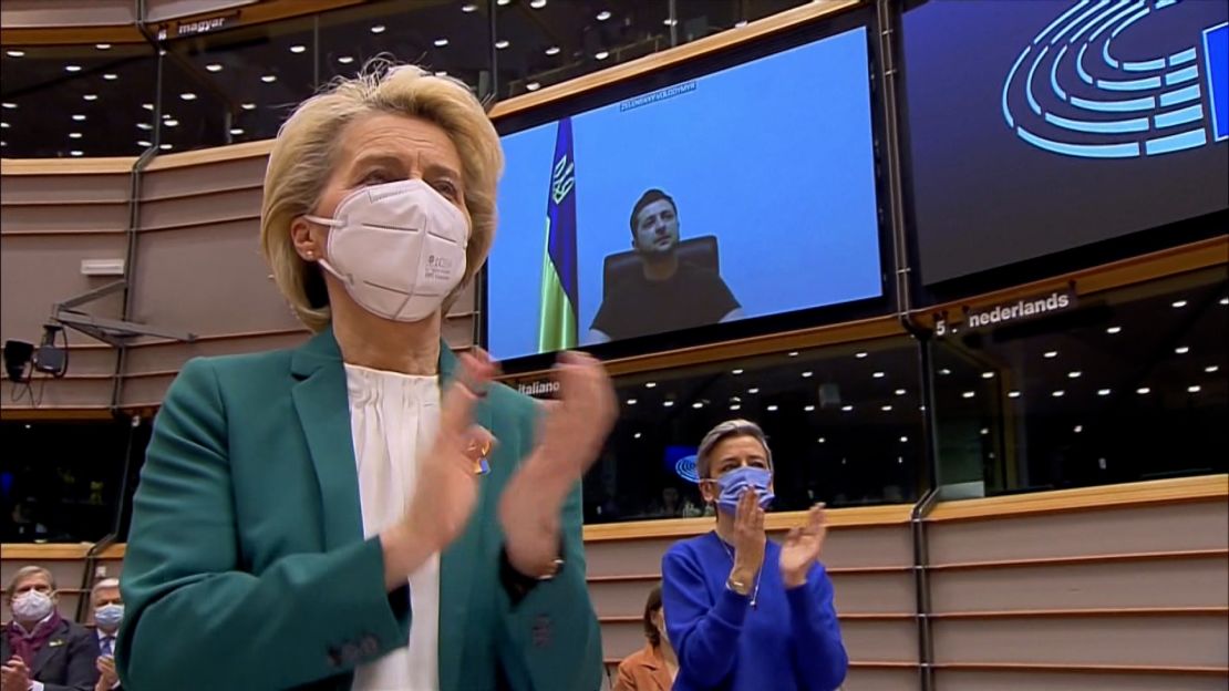 EU chief Ursula von der Leyen, left, applauds in Brussels as Ukrainian President Volodymyr Zelensky makes a speech.