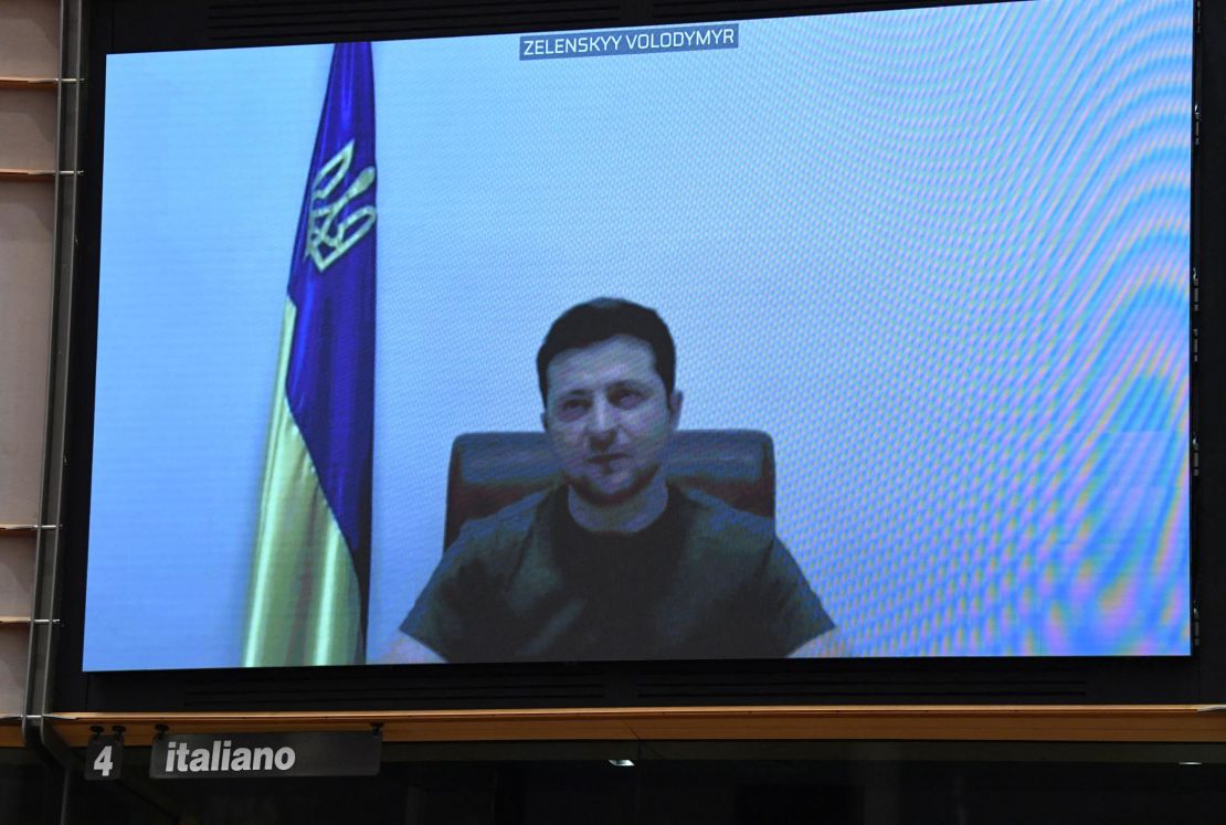 Ukrainian President Volodymyr Zelensky appears on a screen as he speaks in a video conference. 