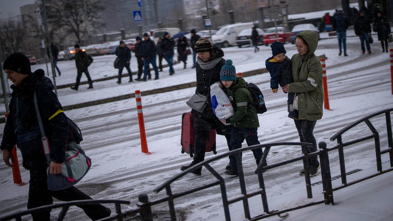 People arrive at a train station as they try to leave Kyiv, Ukraine, Tuesday, March 1, 2022. Explosions and gunfire that have disrupted life since the invasion began last week appeared to subside around Kyiv overnight, as Ukrainian and Russian delegations met Monday on Ukraine's border with Belarus. (AP Photo/Emilio Morenatti)