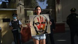 A member of the Ukrainian community holds a banner depicting Russian President Vladimir Putin during a demo against the Russian invasion in Ukraine, outside the Russian Embassy in Mexico City, on February 28, 2022. - Russian President Vladimir Putin launched a full-scale invasion of Ukraine on Thursday, triggering attacks air forces and ordering ground troops throughout the territory. border in combat that, according to the Ukrainian authorities, left dozens dead. (Photo by RODRIGO ARANGUA / AFP) (Photo by RODRIGO ARANGUA/AFP via Getty Images)