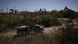 A truck drives past pump jacks operating at the Inglewood Oil Field Thursday, June 10, 2021, in Los Angeles.