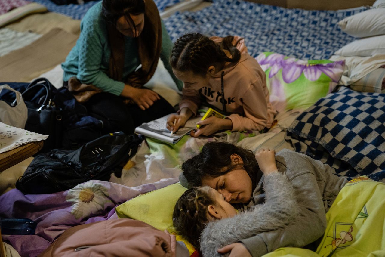 A woman named Helen comforts her 8-year-old daughter, Polina, in the bomb shelter of a Kyiv children's hospital on March 1. The girl was at the hospital being treated for encephalitis, or inflammation of the brain.  Zelensky says Russia waging war so Putin can stay in power &#8216;until the end of his life&#8217; w 1280