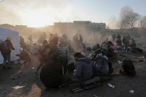 Ukrainian refugees try to stay warm at the Medyka border crossing in Poland on March 1.