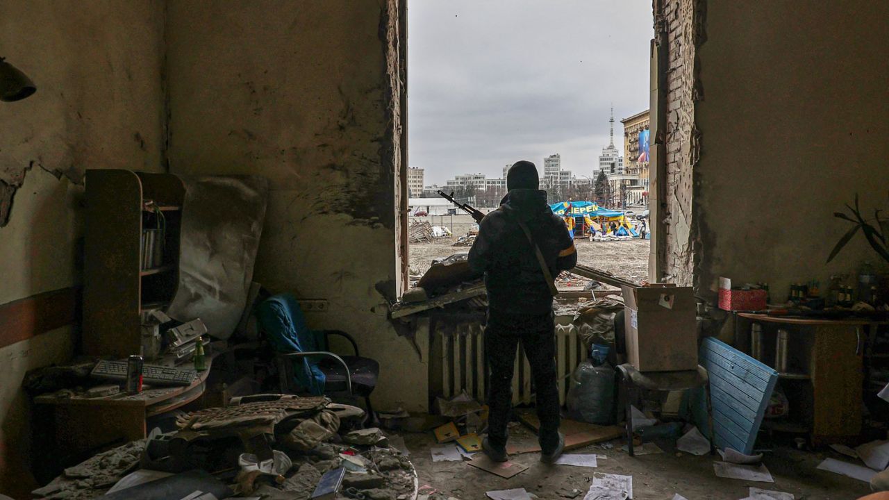 A Ukrainian soldier stands inside the damaged Kharkiv regional administration building, in the aftermath of shelling on March 1, 2022.  