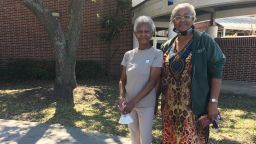 Neighbors Ella Clark, left, and Delores Jones, right, voted in person Tuesday in Houston after encountering problems mail-in voting. 
