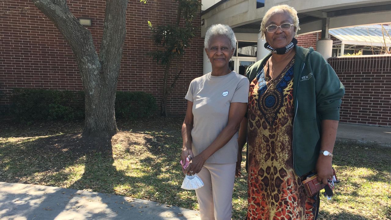 Neighbors Ella Clark, left, and Delores Jones, right, voted in person Tuesday in Houston after encountering problems with voting by mail. 