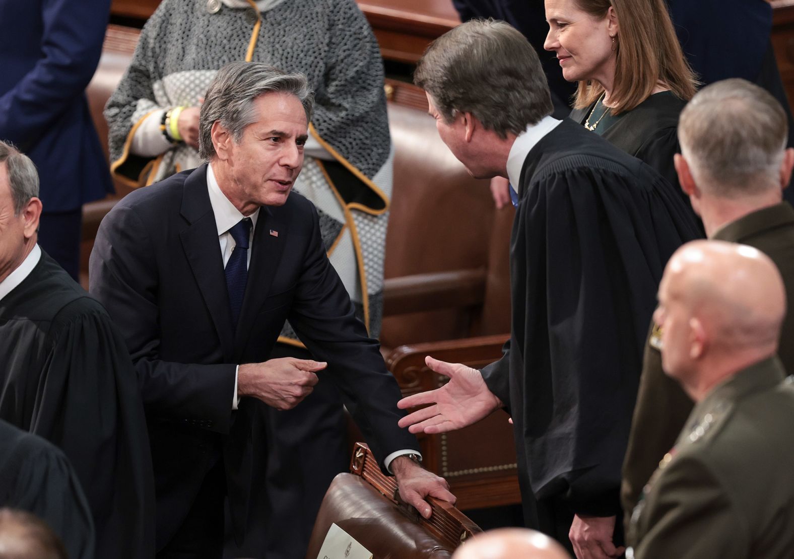 Secretary of State Antony Blinken, left, talks to Supreme Court Justice Brett Kavanaugh before Biden's speech.