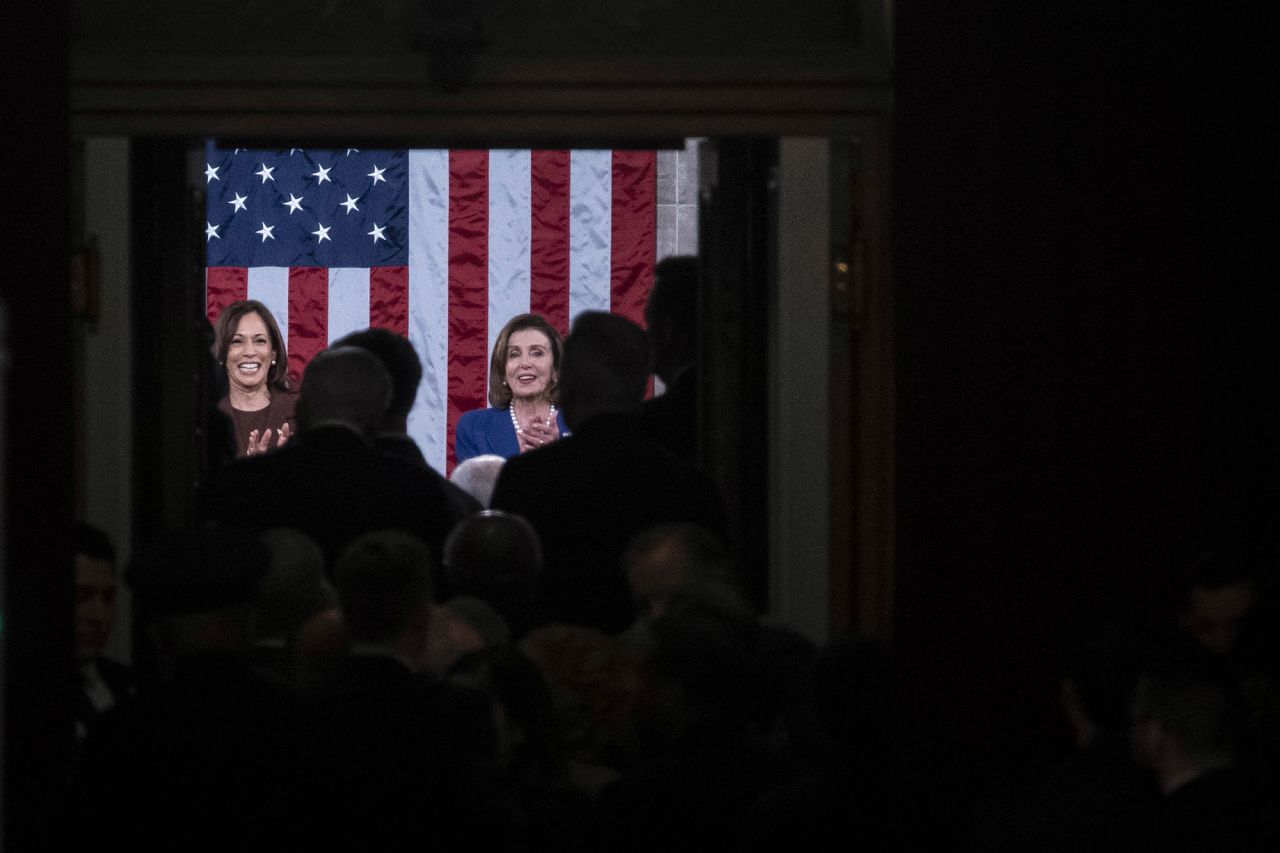 Harris and Pelosi react as Biden enters the chamber.