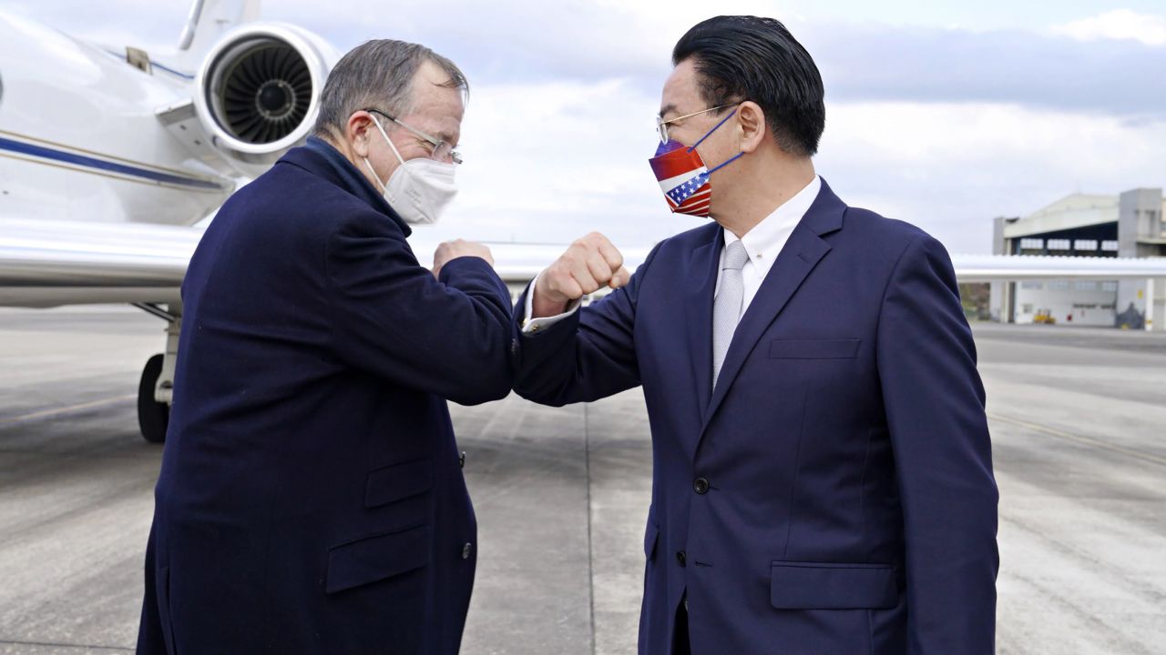 Taiwan's Foreign Minister Joseph Wu, right, greets former Chairman of the Joint Chiefs of Staff Mike Mullen at Taipei Songshan Airport in Taiwan on March 1, 2022.