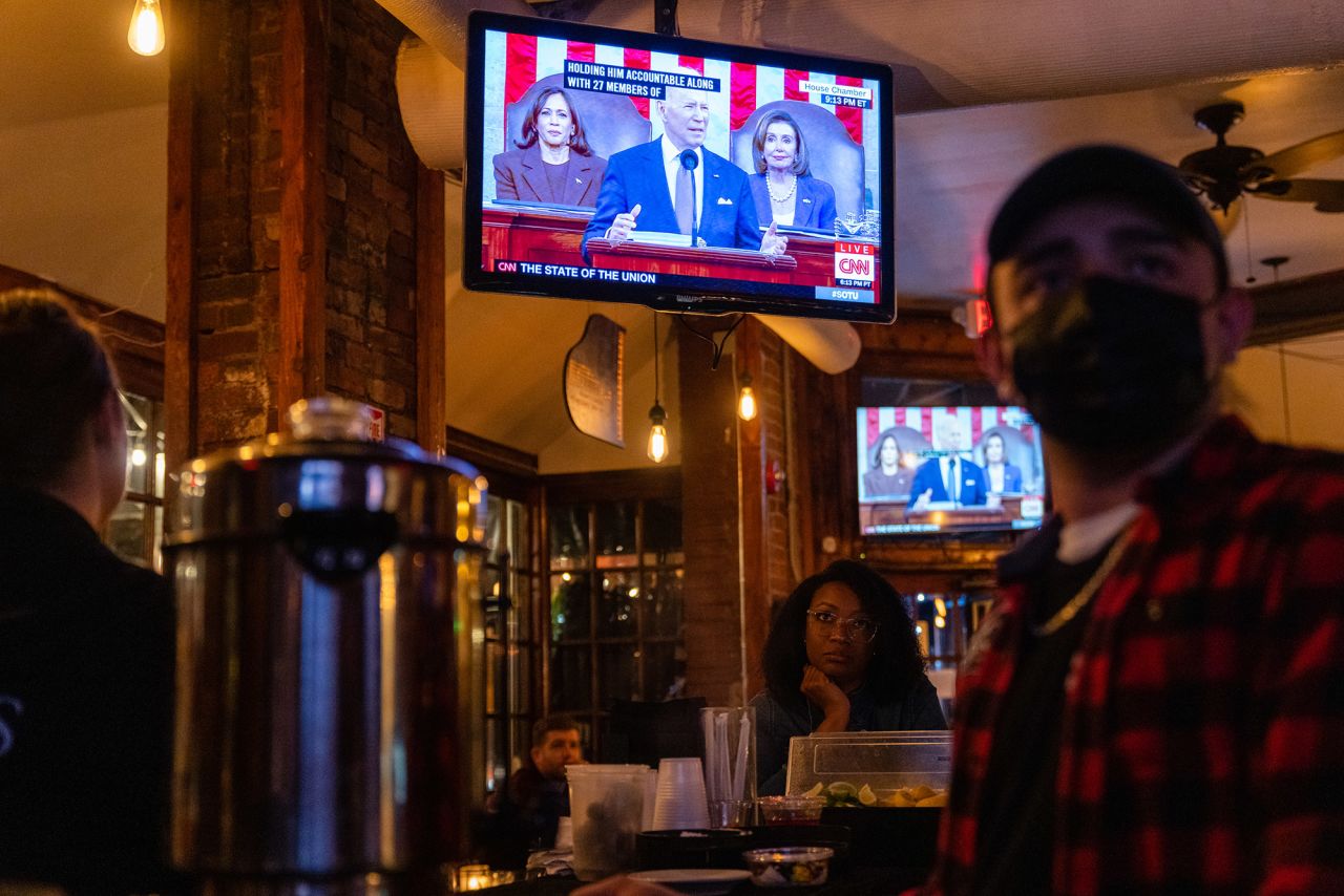 Biden's speech plays on a television at a bar in Washington, DC.