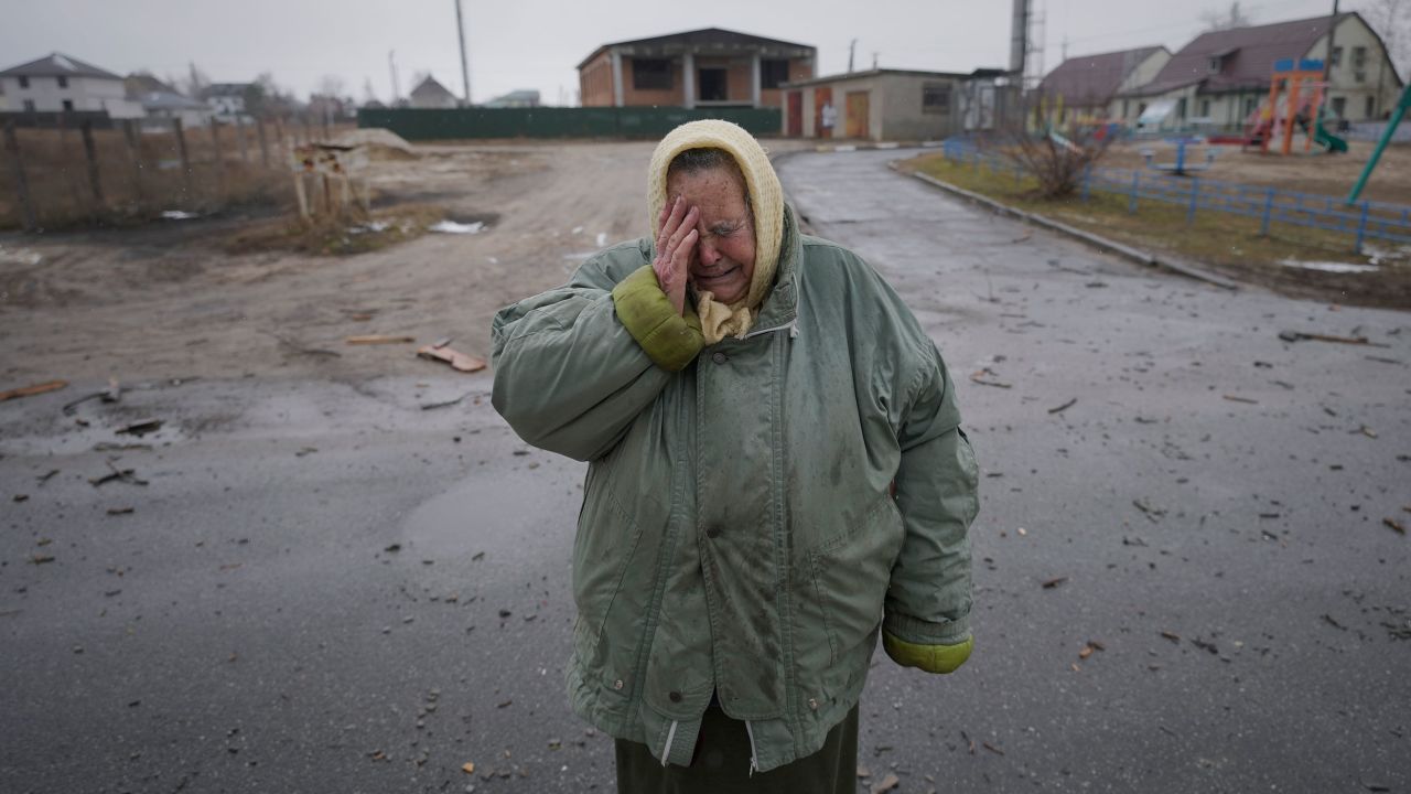 A woman cries outside houses damaged by a Russian airstrike, according to locals, in Gorenka, outside Ukraine's capital, Kyiv, on Wednesday.