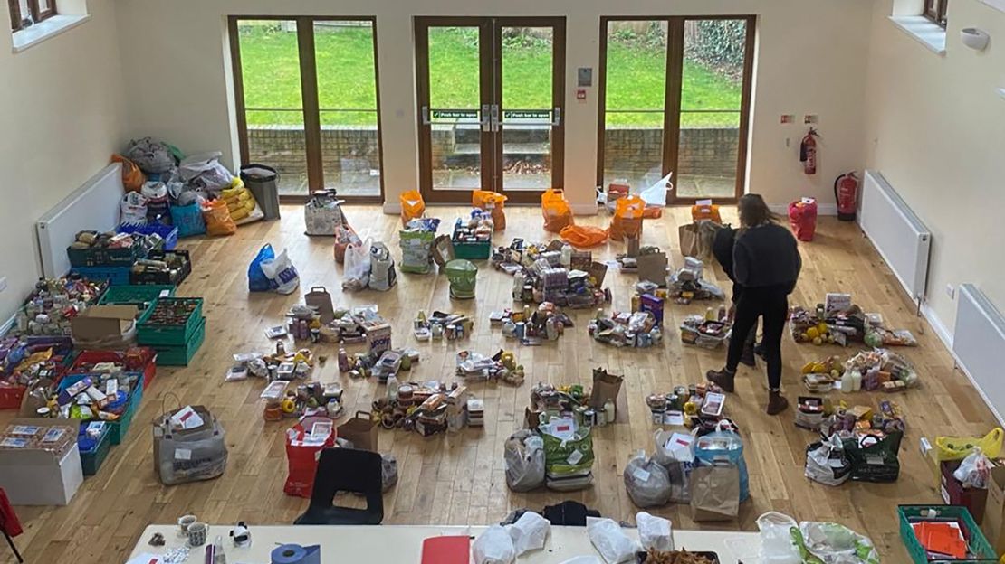 Volunteers at Cooking Champions in London create food parcels using donated and redistributed food.