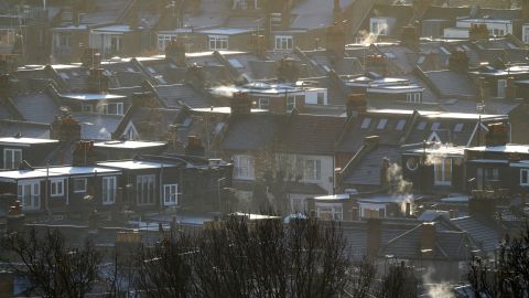 Steam and smoke is seen rising from the chimneys and central heating vents of houses in January in London.