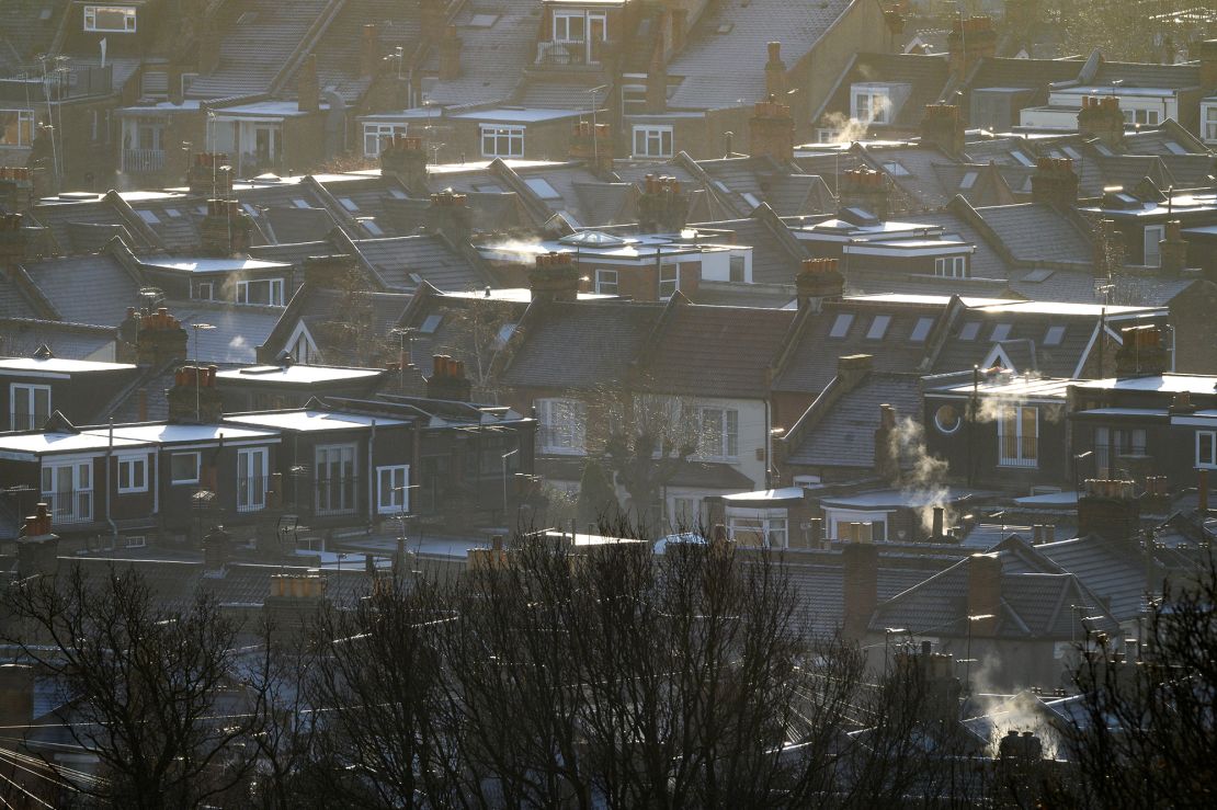 Steam and smoke is seen rising from the chimneys and central heating vents of houses in January in London.