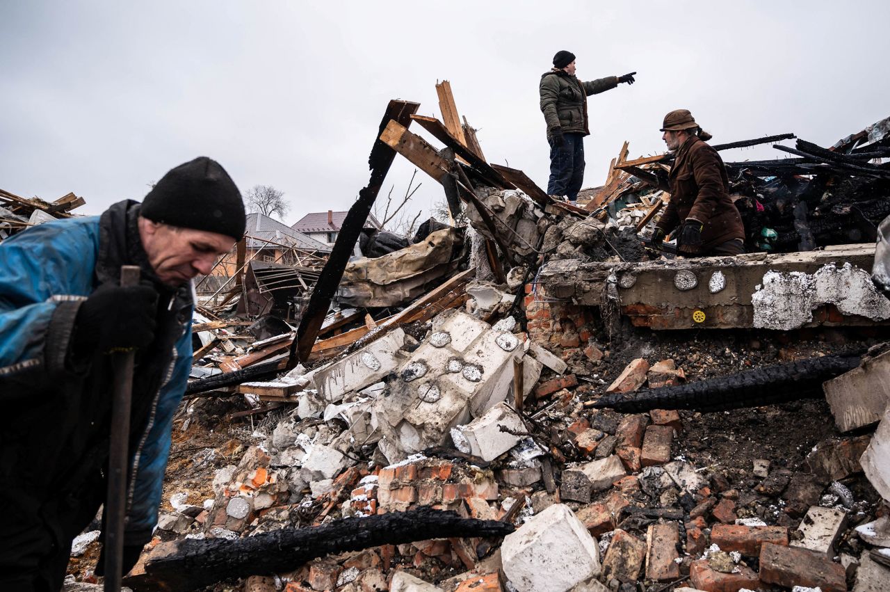 Residents of Zhytomyr work in the remains of a residential building on March 2. The building was destroyed by shelling.