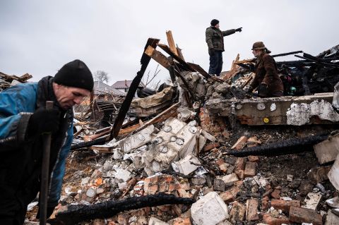 Residents of Zhytomyr, Ukraine, work in the remains of a residential building on March 2. The building was destroyed by shelling.