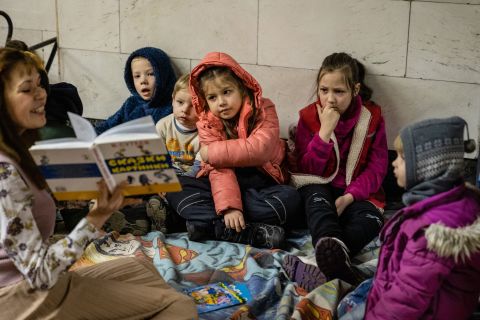 A woman reads a story to children while they take shelter in a subway station in Kyiv on March 2.