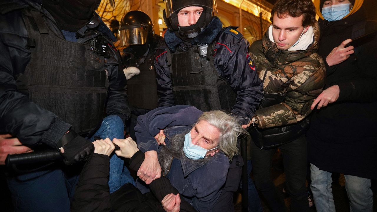 Police officers detain a demonstrator during a protest against Russia's invasion of Ukraine in central Saint Petersburg on February 24, 2022. 